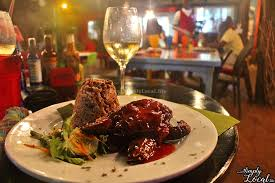 plate of food with a glass of wine